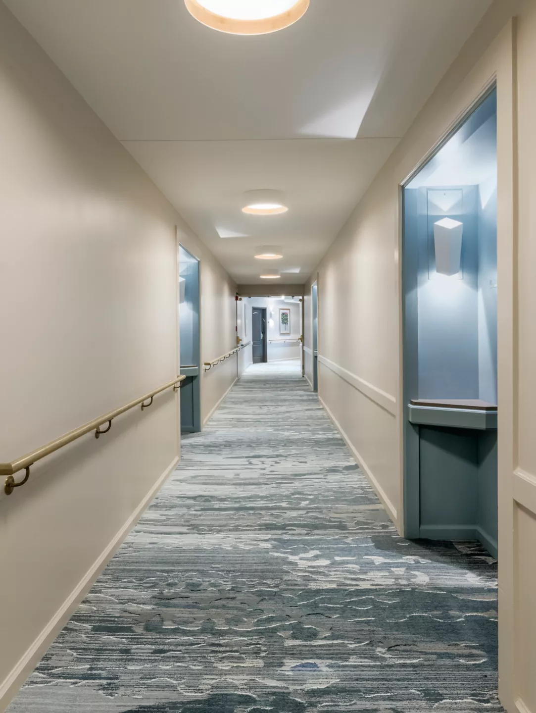 Senior living corridor with slip-resistant resilient flooring, cove base, and safe transitions